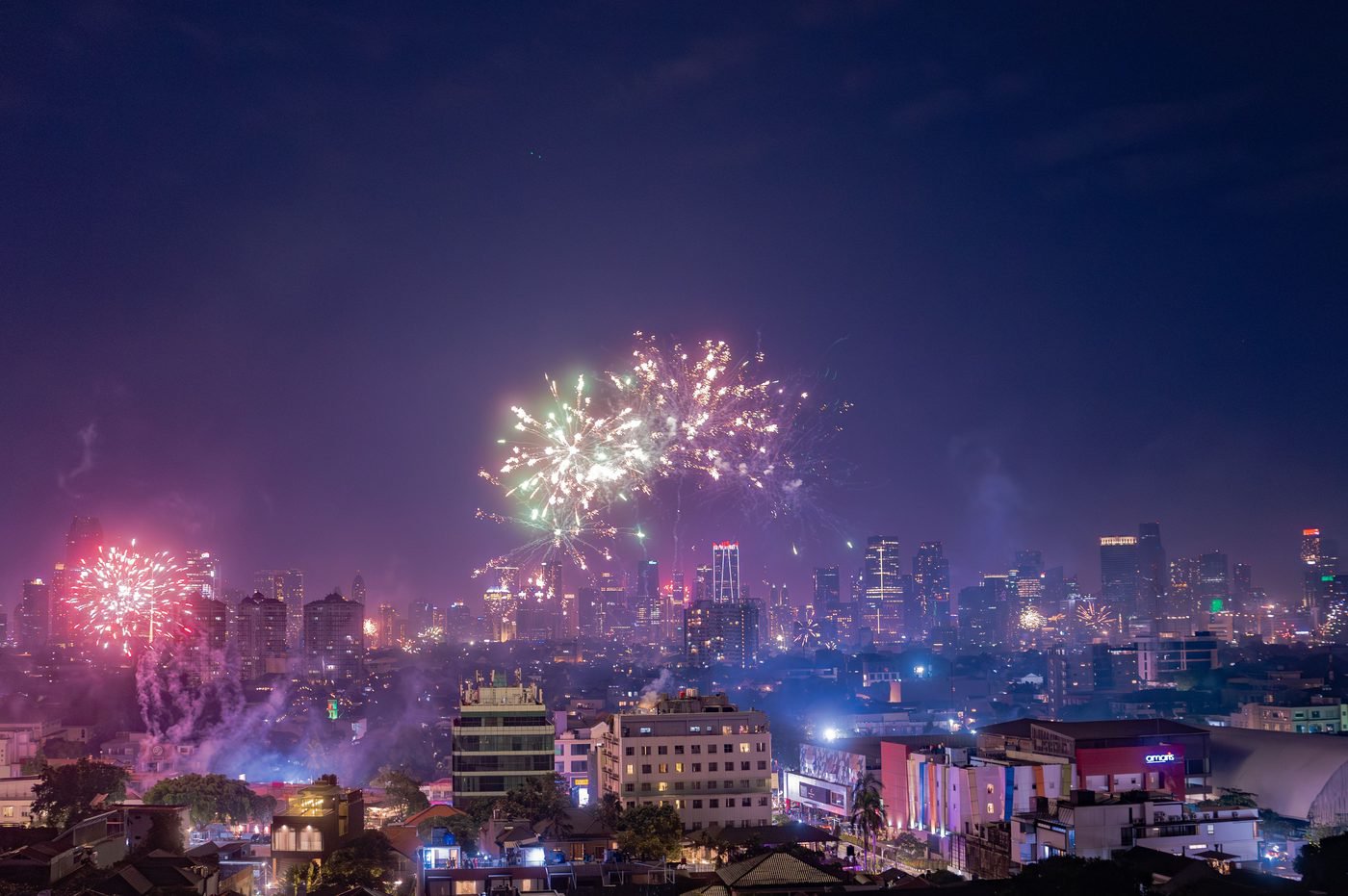 Fireworks display over a city skyline